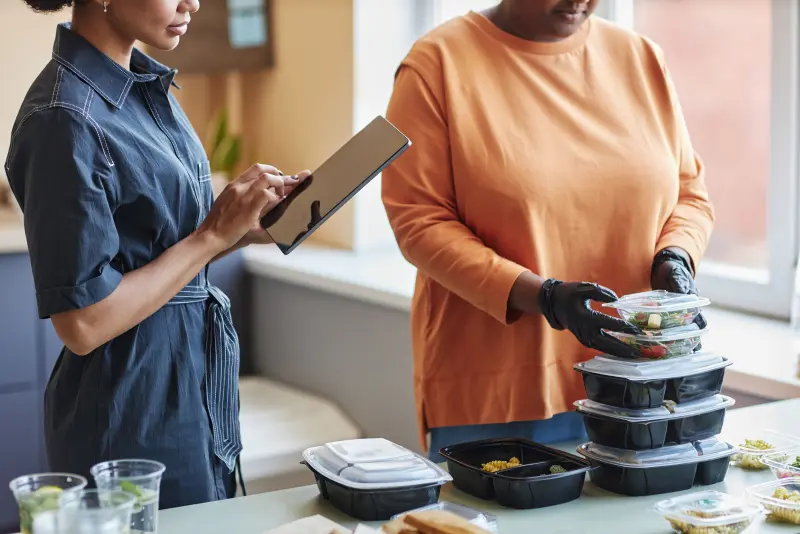 Registered dietitian reviewing a personalized meal plan with a patient Registered dietitian reviewing a personalized meal plan with a patient