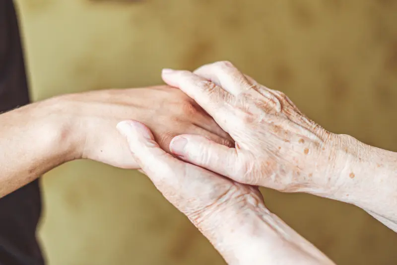Occupational therapist helping a patient practice daily living activities at home Occupational therapist helping a patient practice daily living activities at home