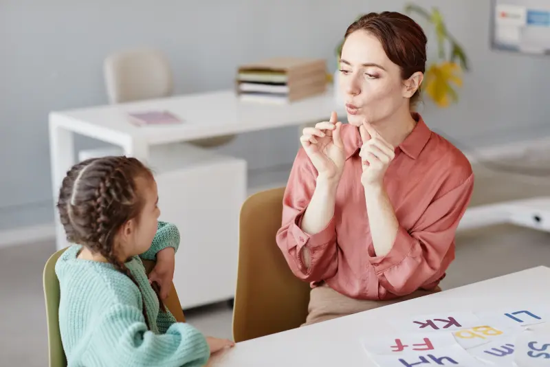 Speech-language pathologist working on communication exercises with a patient Speech-language pathologist working on communication exercises with a patient